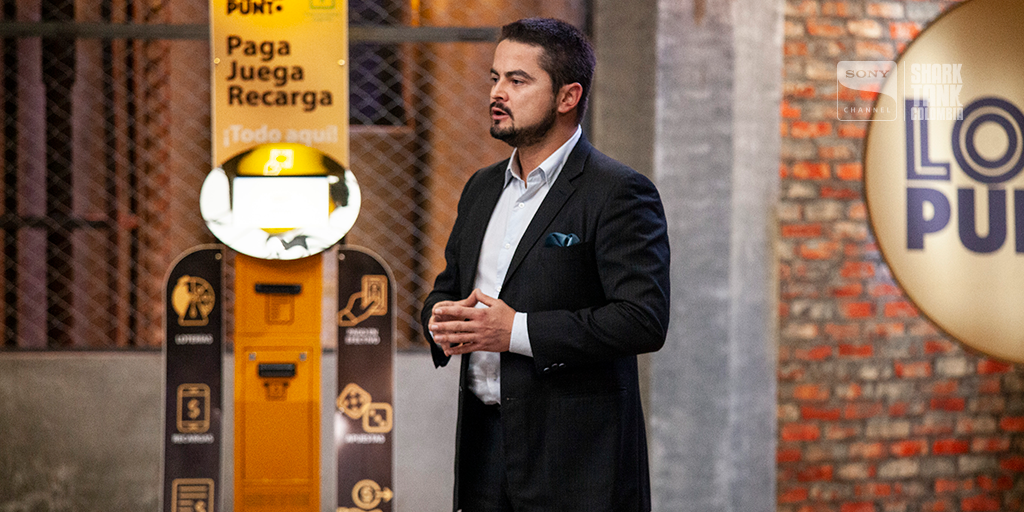 Victor Espinosa, Founder of Loto Punto, stands in front of his product, pitching it on Columbia's Shark Tank