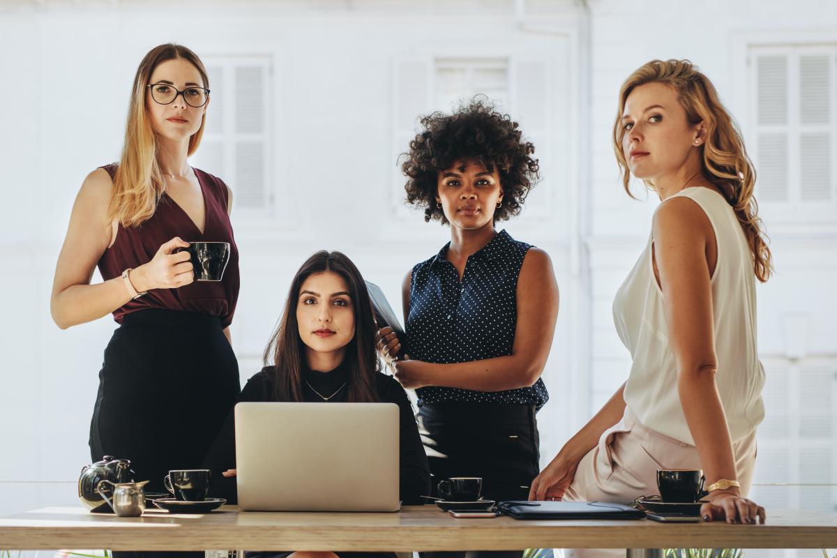 people sitting at a desk with coffee